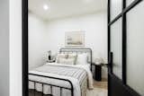 Bedroom, Recessed Lighting, Lamps, Vinyl Floor, and Bed An interior bedroom with a handcrafted metal door and a transom window.  Photo 9 of 19 in Koi St Clair West by meetmiranda