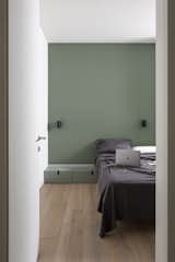 Bedroom, Bench, Light Hardwood Floor, Wardrobe, Bed, and Wall Lighting  Photo 13 of 15 in Pan-00 by Atelierzero