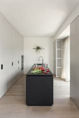 Kitchen, Wall Lighting, Light Hardwood Floor, Cooktops, Granite Counter, Stone Counter, Colorful Cabinet, Wall Oven, and Undermount Sink  Photo 5 of 15 in Pan-00 by Atelierzero