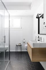 Bath Room, Wood Counter, Corner Shower, Ceramic Tile Floor, Wall Lighting, and Two Piece Toilet  Photo 14 of 15 in Volumes by Atelierzero