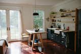 Kitchen, Refrigerator, Wood Counter, Drop In Sink, Colorful Cabinet, Recessed Lighting, Pendant Lighting, Cooktops, Dark Hardwood Floor, and Microwave  Photo 3 of 12 in Carriage House by the lake by Morgan Holland