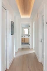 Hall with inset and lit white oak ceiling 