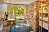 View from the bathroom to the outdoors. The stone wall is the back of the fireplace.