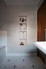 The built-in hamper was removed and replaced with custom decorative niches. 