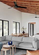 The exposed timber ceiling brings texture to the light walls in the main living space