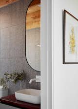 Dark terrazzo finishes in the wet areas create a cooling calmness