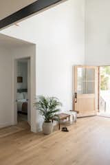 Entryway open door with bench and guest bedroom