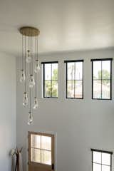 Stairway with windows and chandelier lighting