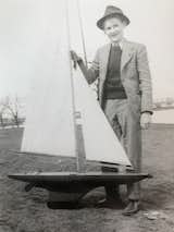 Young Thomas and one of the boats he and his Dad built, using his bedroom as the workshop back during the depression. 