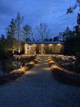 Exterior, Shed RoofLine, Cabin Building Type, and Wood Siding Material Nighttime walkway to the cottage  Photo 4 of 11 in Cypress Cottage by Paul Howard