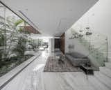 Living Room, Sofa, Ceiling Lighting, Coffee Tables, and Marble Floor Stairs to upper floor  Photo 15 of 28 in Inner Garden Villa by C van Ling