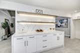 Kitchen and Engineered Quartz Counter Open shelving with under mount LED . Water Fall Quartz counters   Photo 13 of 16 in The Meadow Vista, California Mountain Modern by Gary Khera