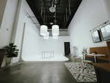 Behind the cyclorama wall, the team built custom storage for the video and photography equipment  to make the space multi-functional. 