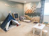 The upstairs playroom that the couple built a custom climbing wall in during COVID for their 3 year old son. 