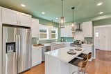 Kitchen, Engineered Quartz Counter, Range Hood, Subway Tile Backsplashe, White Cabinet, Refrigerator, Recessed Lighting, Undermount Sink, Dishwasher, Ceiling Lighting, Range, Wood Cabinet, Pendant Lighting, and Medium Hardwood Floor Kitchen 2  Photo 7 of 11 in Russell Street Transformation by NurtureSource Homes