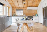 Kitchen, Granite Counter, Microwave, Ice Maker, Medium Hardwood Floor, Ceiling Lighting, Beverage Center, White Cabinet, Refrigerator, Drop In Sink, Cooktops, Dishwasher, Wall Oven, and Wood Backsplashe Kitchen  Photo 4 of 11 in Modern Romantic Cabin by Rachel Phillips