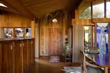Entryway - door, ceiling light and standing piece on the right by James Hubbell