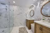 Floor to ceiling wall tile along with heated floors and bidet toilets