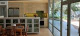 The simple design of the open kitchen follows the original design with modern updates and abundant natural light