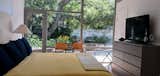 Primary bedroom shares the floor to ceiling glass features of the post and beam design