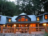 Front deck facing lake.  Central element contains two-story Great Room with Living and Dining.  Upper ffloor is discontinuous providing two places where upper level opens to the two-story central space.  The end of each wing also contains a two-story space, the right end is used as the Master Bedroom, and the opposite end is used as the kids bunk room.
