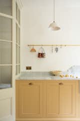 Kitchen, Marble Counter, Light Hardwood Floor, Colorful Cabinet, Pendant Lighting, Marble Backsplashe, and Drop In Sink  Photo 5 of 12 in The Stoke Newington Kitchen by deVOL Kitchens