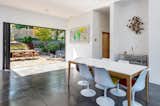 Dining Room, Chair, Concrete Floor, Ceiling Lighting, and Table Dining area indoor / outdoor living  Photo 7 of 15 in Wander Ashville Meadows by Matt Kowalewski