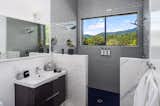 Bath Room, Wall Mount Sink, Ceiling Lighting, Ceramic Tile Wall, Concrete Floor, and Open Shower Primary bathroom  Photo 12 of 15 in Wander Ashville Meadows by Matt Kowalewski