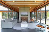 Trendy living room with Herman Miller Chair and smart controlled fire place  Photo 3 of 20 in Hudson Woods Pool House by Matt Kowalewski