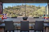 Dining Room, Concrete Floor, Chair, Table, and Bench  Photo 5 of 20 in Hidden Valley Desert House by Matt Kowalewski
