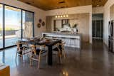 Kitchen, Range, Refrigerator, Wall Oven, Wood Cabinet, Microwave, and Dishwasher Dining area  Photo 13 of 17 in Modern Oasis in Joshua Tree by Matt Kowalewski