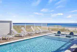 Beach-side pool with lounge chairs 