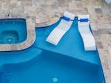 Lounge chairs and pool in backyard 