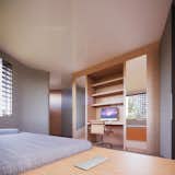 Bedroom, Shelves, Storage, Wardrobe, Bookcase, Medium Hardwood Floor, Dresser, Bed, and Chair  Photo 15 of 23 in RtecH|VE by EK Architecture, PLLC | onE.GLobe