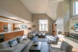 Living Room, Chair, Gas Burning Fireplace, Two-Sided Fireplace, Sectional, Sofa, Bookcase, Corner Fireplace, Ceiling Lighting, Coffee Tables, and Porcelain Tile Floor Family Room/Kitchen  Photo 4 of 7 in Chang Renovation by John Lynch