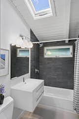Bath Room, Engineered Quartz Counter, Wall Lighting, Ceramic Tile Wall, Undermount Sink, Alcove Tub, and Ceramic Tile Floor  Photo 9 of 19 in Paul Hammarberg Home by Alissa Custer