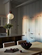 A view across the dining table showcasing the floor to ceiling cabinetry 