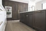 Custom state-of-the-art kitchen with two-tone cabinetry complimented by gold hardware and Gaggeneau Appliances 