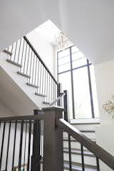 Oak staircase with large window overlooking the front yard