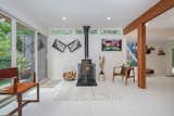 Living Room, Wood Burning Fireplace, Ceiling Lighting, Accent Lighting, Recessed Lighting, and Chair  Photo 13 of 14 in East Grand Rapids Mid Century Modern by Shaun Anders