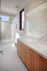 The outdoor shower opens to the sky above and is divided from the interior by a cover glass panel next to the indoor shower. 

