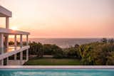 Outdoor, Back Yard, Concrete Patio, Porch, Deck, Small Pools, Tubs, Shower, Shrubs, Concrete Pools, Tubs, Shower, Grass, Large Patio, Porch, Deck, Stone Patio, Porch, Deck, and Landscape Lighting sunset view river the ocean  Photo 1 of 16 in THE AVEN by Jelle Vans photography