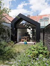 The irregular gable roof and black cladding make for a contemporary building.