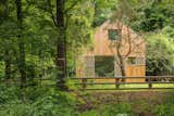Exterior, Cabin Building Type, Metal Roof Material, Wood Siding Material, and Gable RoofLine Weekend House in the Woods from the path  Photo 2 of 15 in A Cute Cabin Serves Up the Simple Life for a Couple Looking to Escape the City from Weekend House in the Woods
