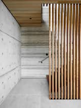 Staircase, Concrete Tread, Metal Railing, and Wood Tread Wood slats by Sculptform were used both inside and out.  Size, spacing, and finish were all carefully selected to provide privacy, textural variation, and warmth to the project.  Photo 2 of 27 in Haiku House by See Arch