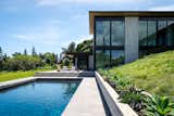 Exterior hardscaping is oriented to optimize both the hill's natural topography and ocean views.