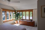 After: The primary bedroom occupies an area that was formerly a study and a shared bathroom. Unfinished wood windows and white oak flooring are a new addition. 