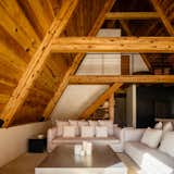 The living room is a popular gathering spot. Tucked into the original section of the A-frame structure, it's protected against the elements but still has a view out into the surrounding forest.
