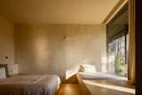 Bedrooms are kept simple with stucco walls and large windows. A trundle pulls out from under the larger bed to better accommodate large groups of guests. 