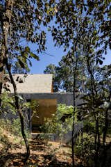 Architect Pablo Pérez Palacios wanted the new addition to feel rooted in its surroundings, so he used a natural-colored handmade stucco with black pigments for the exterior. 